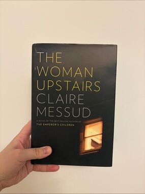 The Woman Upstairs by Claire Messud - Black Cover with Yellow Text